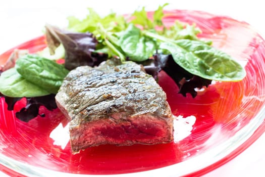 Grilled roast beef and leaf salads on a plate