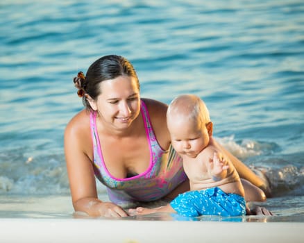 Baby and mother on the tropical beach
