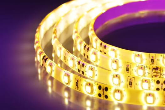 Macrodetail of a warm white LED strip in coloured light