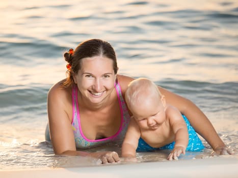 Baby and mother on the tropical beach