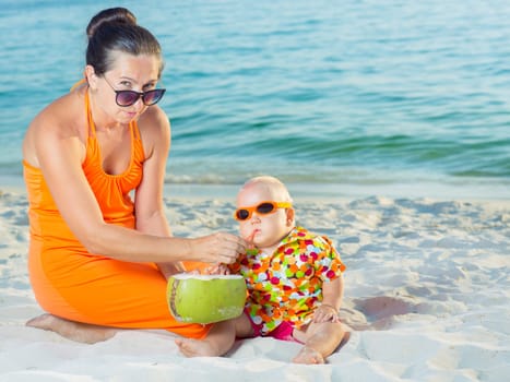 Baby and mother on the tropical beach