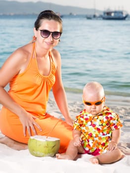 Baby and mother on the tropical beach