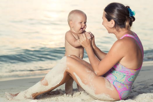 Baby and mother on the tropical beach