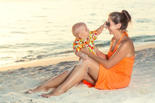 Baby and mother on the tropical beach