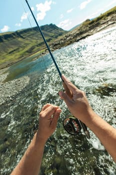 Man fishing for salmon in a beautiful surrounding