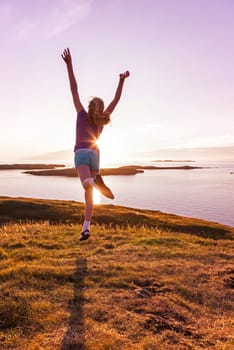 Young girl enjoying life in a beautiful sunset