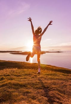Young girl enjoying life in a beautiful sunset