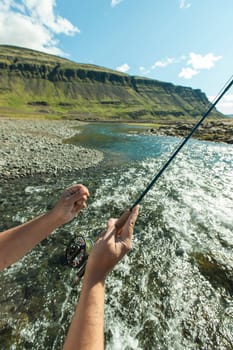 Man fishing for salmon in a beautiful surrounding