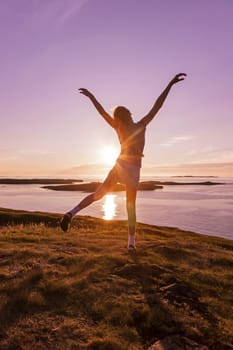 Young girl enjoying life in a beautiful sunset