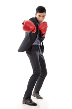Asian businessman with boxing gloves, full length portrait isolated on white background. Concept about fight, struggle, against etc.