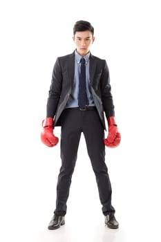 Asian businessman with boxing gloves, full length portrait isolated on white background. Concept about fight, struggle, against etc.