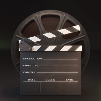 Clapperboard in the foreground with a roll of film in the background.