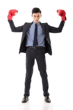 Asian businessman with boxing gloves, full length portrait isolated on white background. Concept about fight, struggle, against etc.