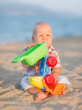 Cute baby is playing toy car