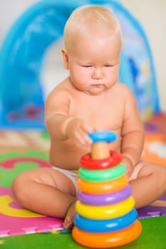 Cute baby is playing toy
