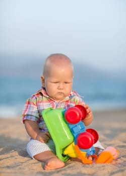 Cute baby is playing toy car