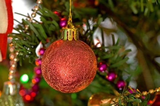 Some christmas balls decorated on a tree