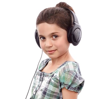 Young cute girl listening something on headphones