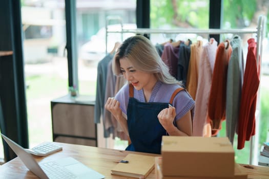 Portrait Of Asian Female Owner Of Fashion Store Clothing Store successful happy smile at small business, sme or ecommerce concepts.