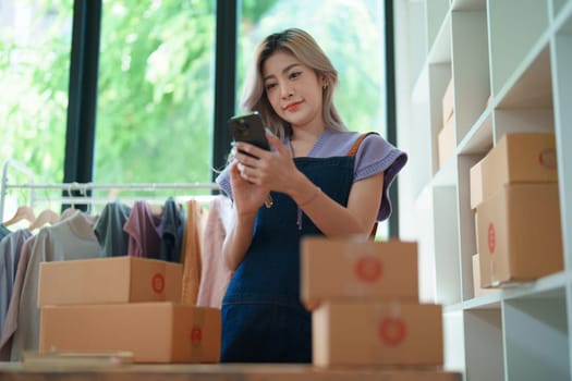 Asian female business owner handles delivery of orders to customers.