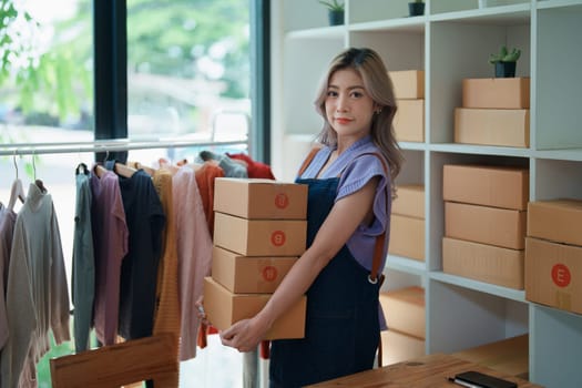 Portrait Of Asian Female Owner Of Fashion Store Clothing Store successful happy smile at small business, sme or ecommerce concepts.