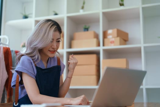 Portrait Of Asian Female Owner Of Fashion Store Clothing Store successful happy smile at small business, sme or ecommerce concepts.