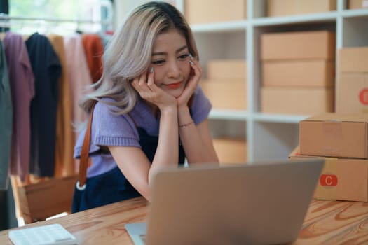 Portrait Of Asian Female Owner Of Fashion Store Clothing Store successful happy smile at small business, sme or ecommerce concepts.