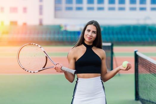 Beautiful stylish sexy woman in a trendy sportswear on tennis court.