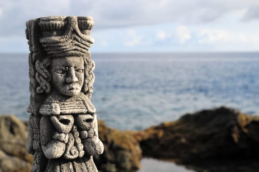 Ancient Maya Statue on the Rocks near Ocean