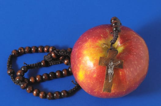 Bible Eva's Sin Red Apple over a Colored Background