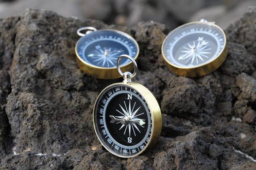 Orientation Concept - Analogic Compass Abandoned on the Rocks
