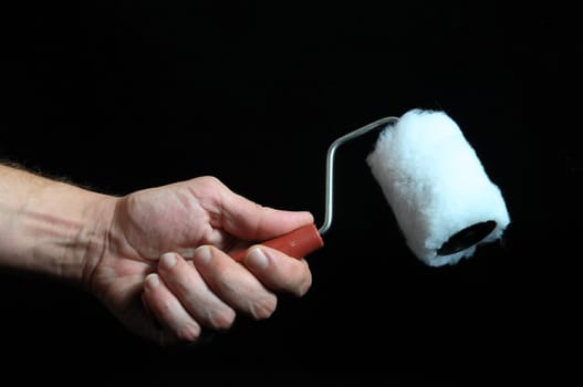 Roll Brush And an Hand on a Black Background