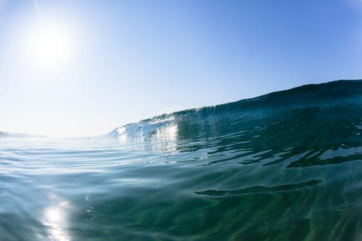 Ocean sea wave vertical crashing hollow tubing water power on shallow beach reefs sandbars, a swimming surfer action water photo