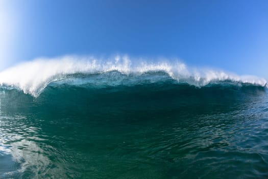 Ocean sea wave vertical crashing hollow tubing water power on shallow beach reefs sandbars, a swimming surfer action water photo