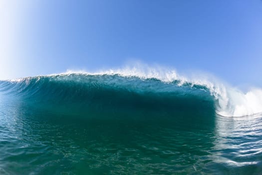 Ocean sea wave vertical crashing hollow tubing water power on shallow beach reefs sandbars, a swimming surfer action water photo
