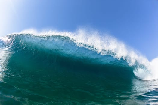 Ocean sea wave vertical crashing hollow tubing water power on shallow beach reefs sandbars, a swimming surfer action water photo