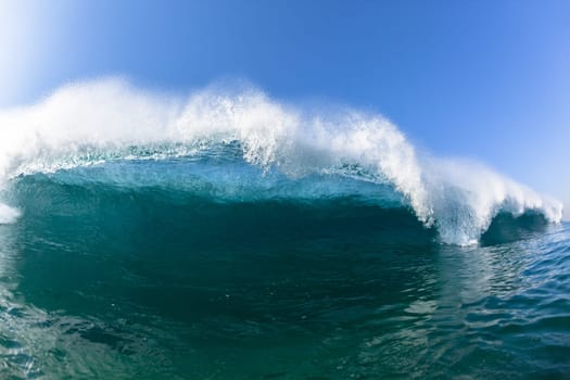 Ocean sea wave vertical crashing hollow tubing water power on shallow beach reefs sandbars, a swimming surfer action water photo