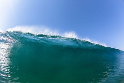 Ocean sea wave vertical crashing hollow tubing water power on shallow beach reefs sandbars, a swimming surfer action water photo