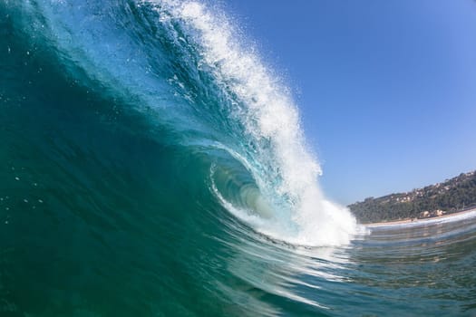 Ocean sea wave vertical crashing hollow tubing water power on shallow beach reefs sandbars, a swimming surfer action water photo