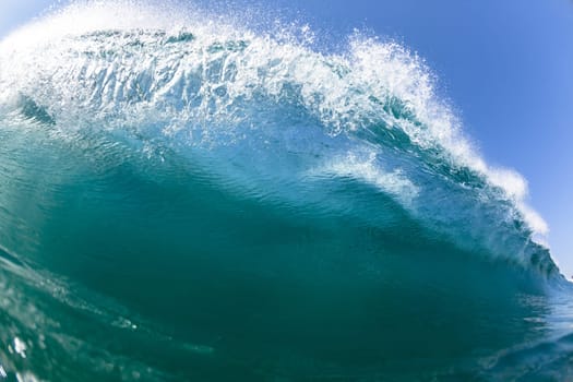 Ocean sea wave vertical crashing hollow tubing water power on shallow beach reefs sandbars, a swimming surfer action water photo