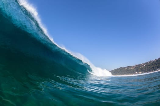 Ocean sea wave vertical crashing hollow tubing water power on shallow beach reefs sandbars, a swimming surfer action water photo