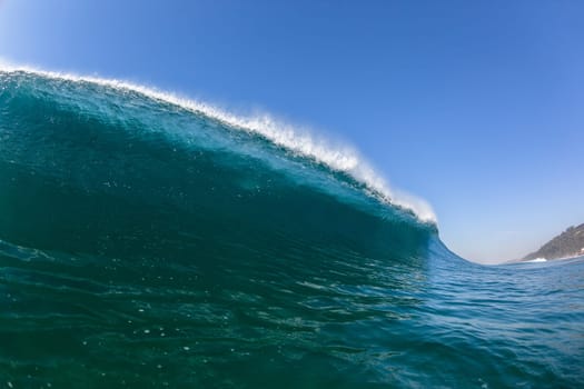 Ocean sea wave vertical crashing hollow tubing water power on shallow beach reefs sandbars, a swimming surfer action water photo
