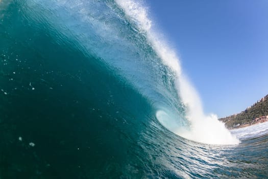 Ocean sea wave vertical crashing hollow tubing water power on shallow beach reefs sandbars, a swimming surfer action water photo