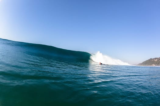 Ocean sea wave with surfer pushing under vertical crashing hollow tubing water power on shallow beach reefs sandbars, a swimming water photo