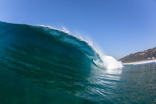 Ocean sea wave vertical crashing hollow tubing water power on shallow beach reefs sandbars, a swimming surfer action water photo