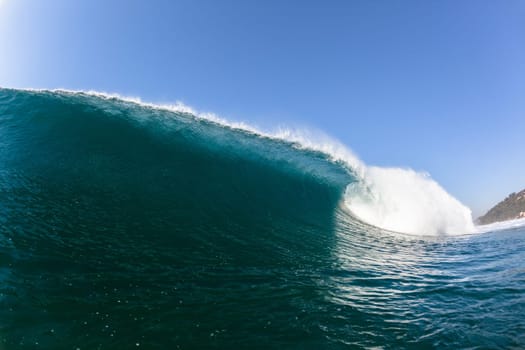 Ocean sea wave vertical crashing hollow tubing water power on shallow beach reefs sandbars, a swimming surfer action water photo