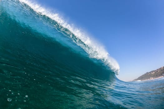 Ocean sea wave vertical crashing hollow tubing water power on shallow beach reefs sandbars, a swimming surfer action water photo