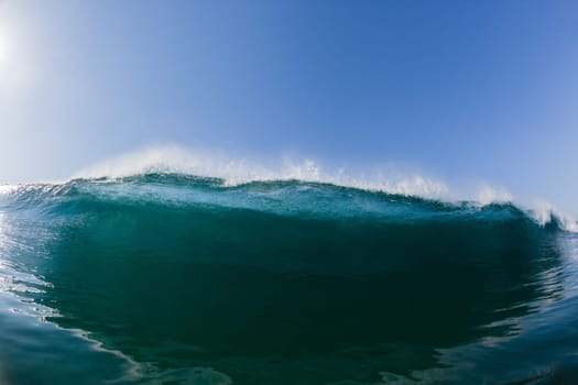 Ocean sea wave vertical crashing hollow tubing water power on shallow beach reefs sandbars, a swimming surfer action water photo