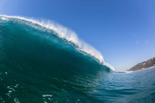 Ocean sea wave vertical crashing hollow tubing water power on shallow beach reefs sandbars, a swimming surfer action water photo