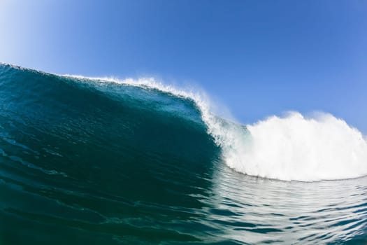 Ocean sea wave vertical crashing hollow tubing water power on shallow beach reefs sandbars, a swimming surfer action water photo